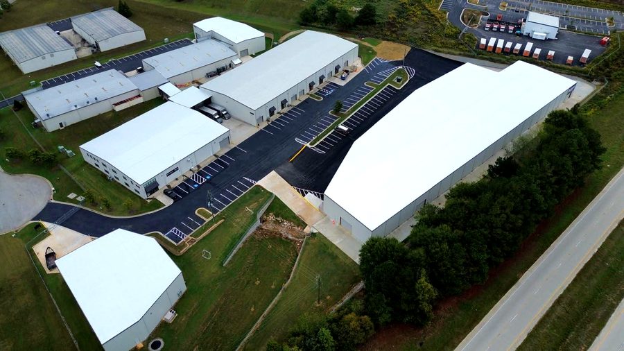 Aerial view of a commercial site with new paving and buildings